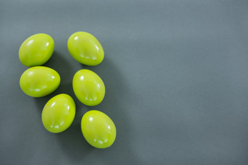 Green Easter eggs on grey background