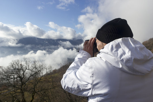 hiker takes picture of a mountain landscape