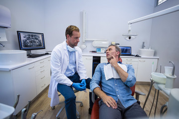 Dentist talking to male patient