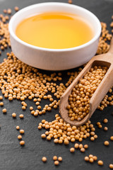 fresh mustard oil on a rustic background