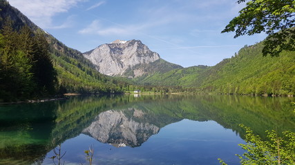 Fototapeta na wymiar mountain reflecting in calm lake
