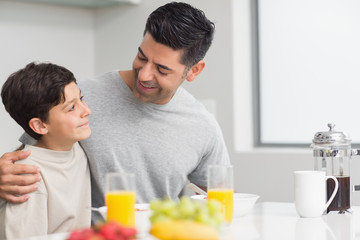 Obraz na płótnie Canvas Young son with father having breakfast