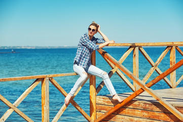 Portrait of a young woman on the beach. Girl resting on the seashore