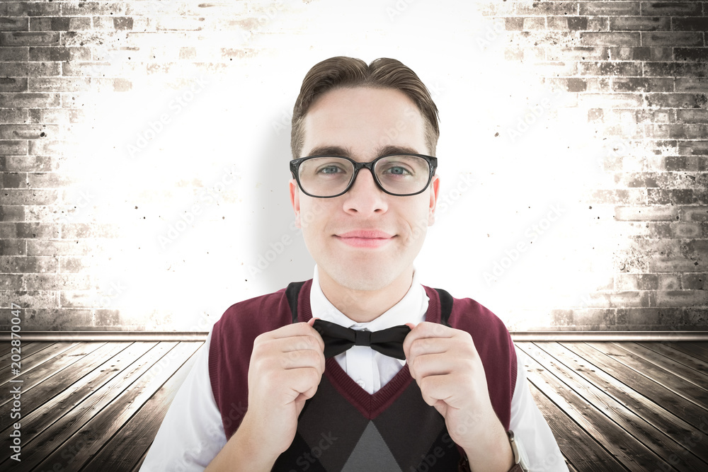 Poster smiling geeky hipster looking at camera against grey background with vignette