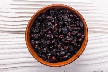 dried barberry berries on the rustic background