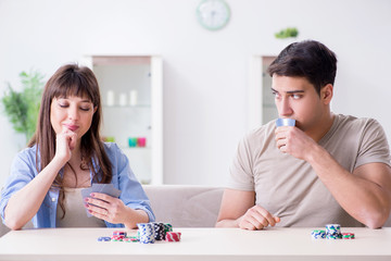 Young family playing cards at home