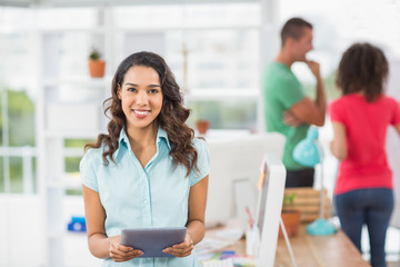 Smiling young woman using digital tablet