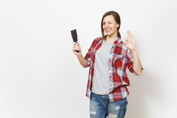 Young smiling beautiful woman in casual clothes holding putty knife and showing OK gesture isolated on white background. Instruments, accessories for renovation apartment room. Repair home concept.