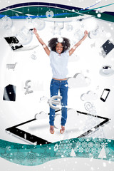 Composite image of a Cheerful woman jumping on a tablet pc against snow falling