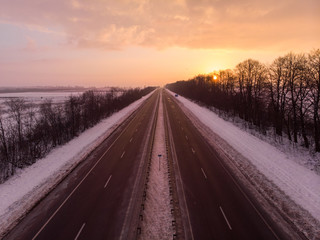 beautiful sunrise aerial view above highway. car travel concept