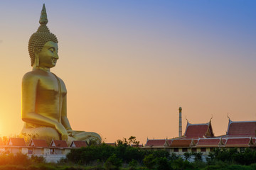 Biggest golden Buddha statue on the green field  in Thailand at Wat Muang, Ang Thong Province, Thailand