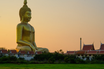 Biggest golden Buddha statue on the green field  in Thailand at Wat Muang, Ang Thong Province, Thailand