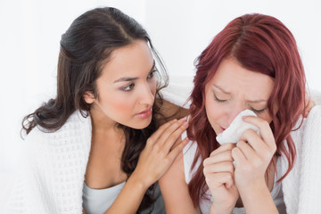 Young woman consoling a crying female friend