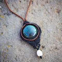 Natural gemstone necklace on rocky backround