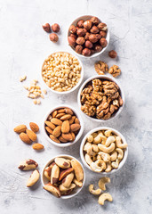 Nuts assortments on stone table top view.