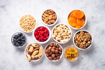 Nuts and dried fruits assortment on stone table top view.