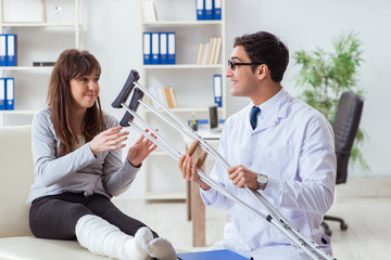 Doctor examining patient with broken leg