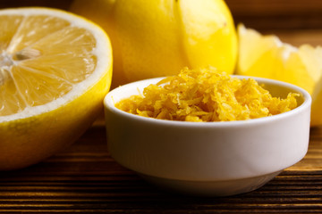 Lemon and juice on a wooden background