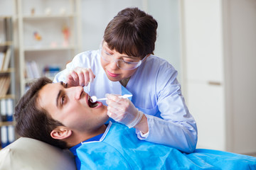 Obraz na płótnie Canvas Woman dentist doctor with male patient in hospital