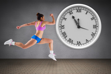 Composite image of fit brunette running against room with wooden floor