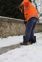 Fototapeta premium Snow spreader shovels the sidewalks after the snowfall