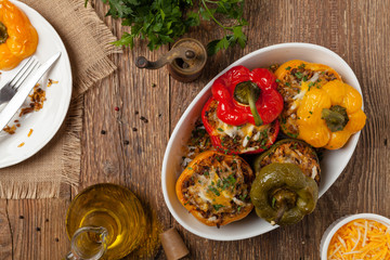 Colorful baked with cheese, stuffed peppers with rice and minced meat.