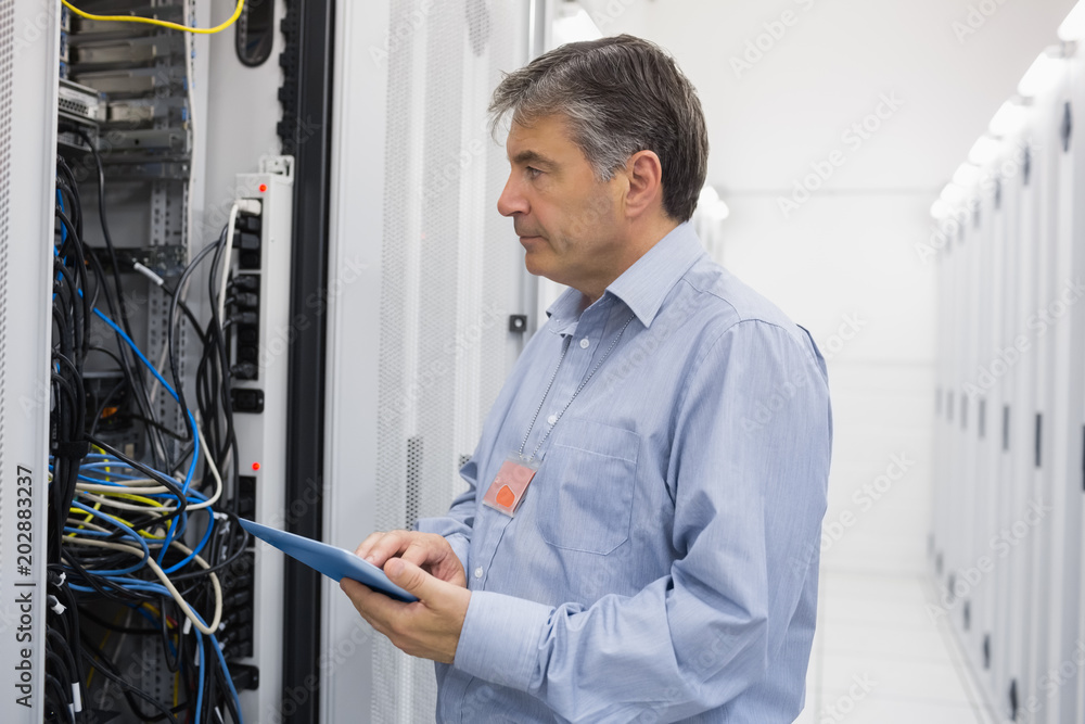 Aufkleber Man using tablet for maintenance on servers