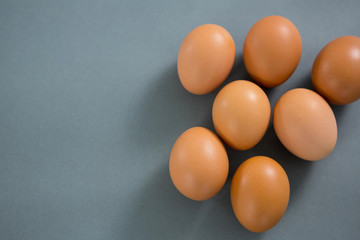 Brown eggs on grey background