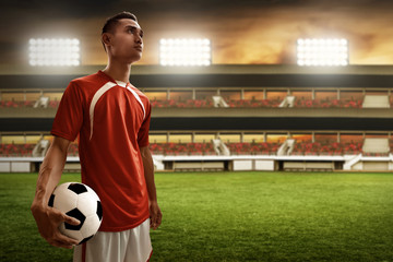 Soccer player holding soccer ball