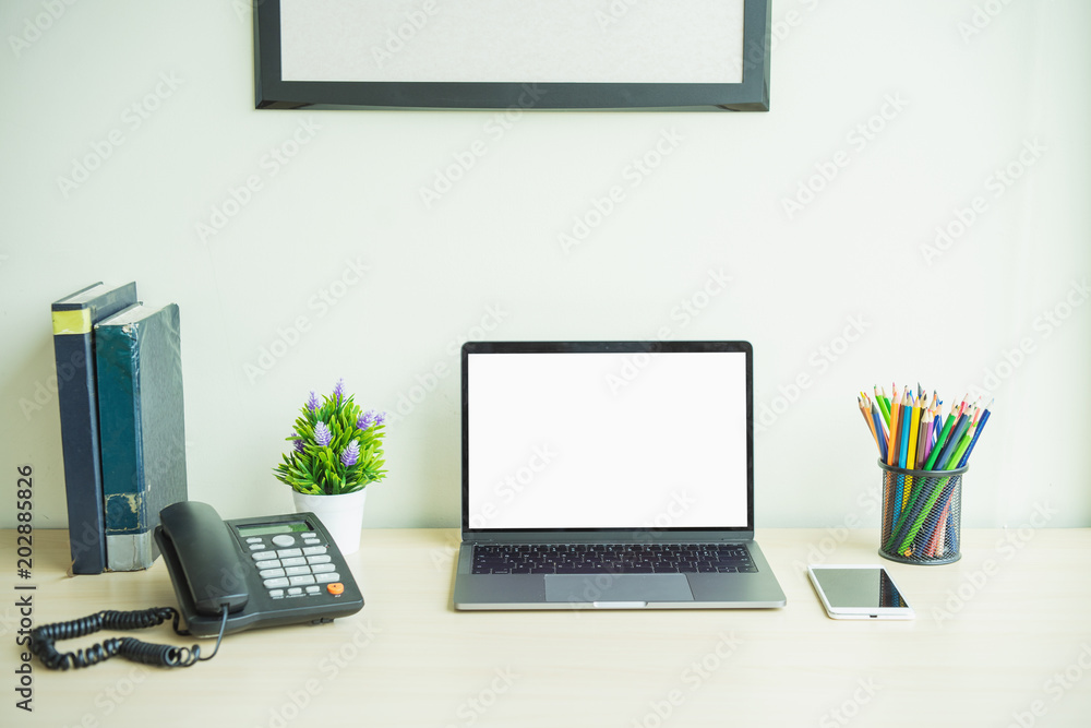 Poster laptop computer showing blank screen on work table
