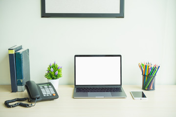 laptop computer showing blank screen on work table