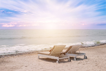 Fototapeta na wymiar Two sun-beds on tropical beach - vacation time