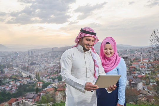 Muslim couple using tablet