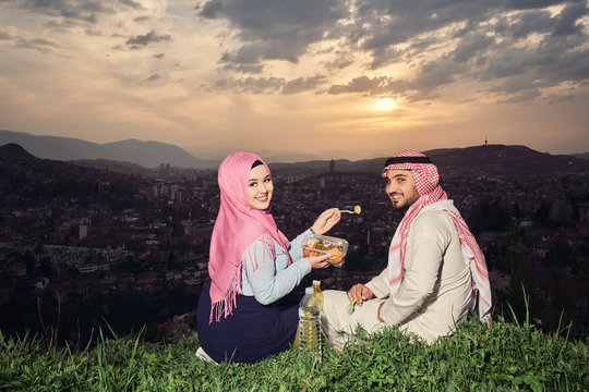 Arabic couple fasting at sunset