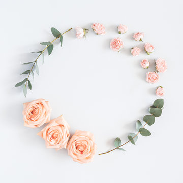 Flowers composition. Wreath made of rose flowers, eucalyptus branches on pastel gray background. Flat lay, top view, copy space, square