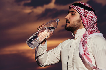 Muslim drinking water at sunset