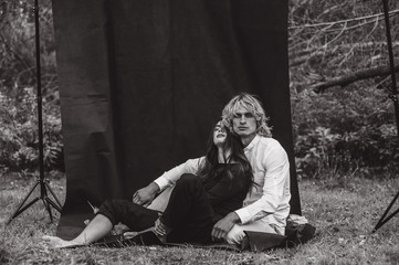 A beautiful couple on a black background is full of emotions