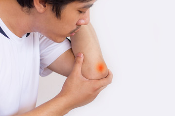Obraz premium Man suffering from elbow pain and feeling bad on white background,Health care concept