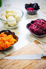 preparing russian traditional salad 'herring under fur coat'