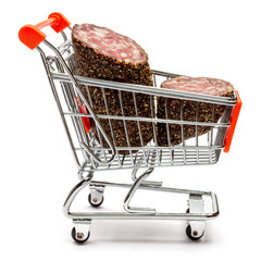 Salami smoked sausage in shopping cart on white background
