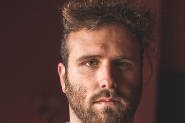 Obraz premium Portrait of a young guy with modern hair and a straight face