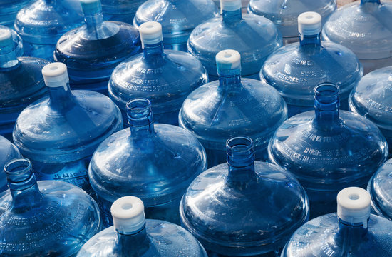 big empty water bottles in a row