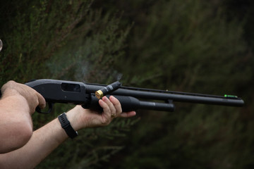 Firing Pump Action Shotgun With Shell Coming Out Of Barrel
