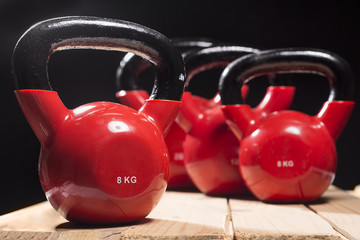 Naklejka na ściany i meble red kettlebells on rough surface.copy space