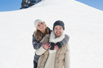 Fototapeta na wymiar Couple in warm clothing on snowed landscape