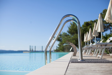 Obraz na płótnie Canvas luxury swimming pool entrance with loungers