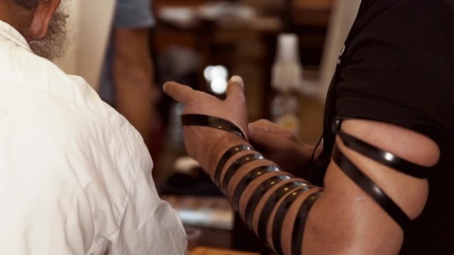 Jewish man put on the hand a tefillin
