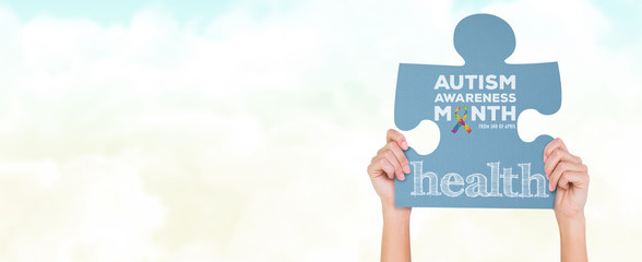 Hands showing jigsaw puzzle against blue sky