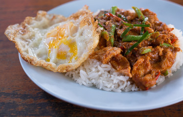 Thai rice with fried pork and curry (Khao Pad Prick Kaeng Hmu) and egg fried close