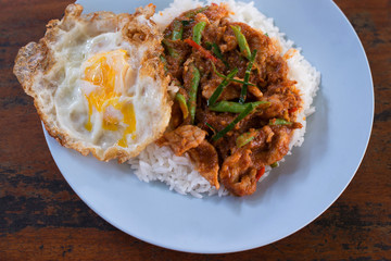 Thai rice with fried pork and curry (Khao Pad Prick Kaeng Hmu) and egg fried close